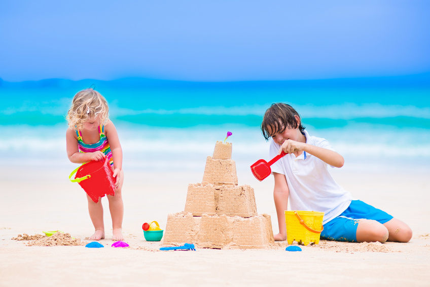 Kids building sand castle on a beach